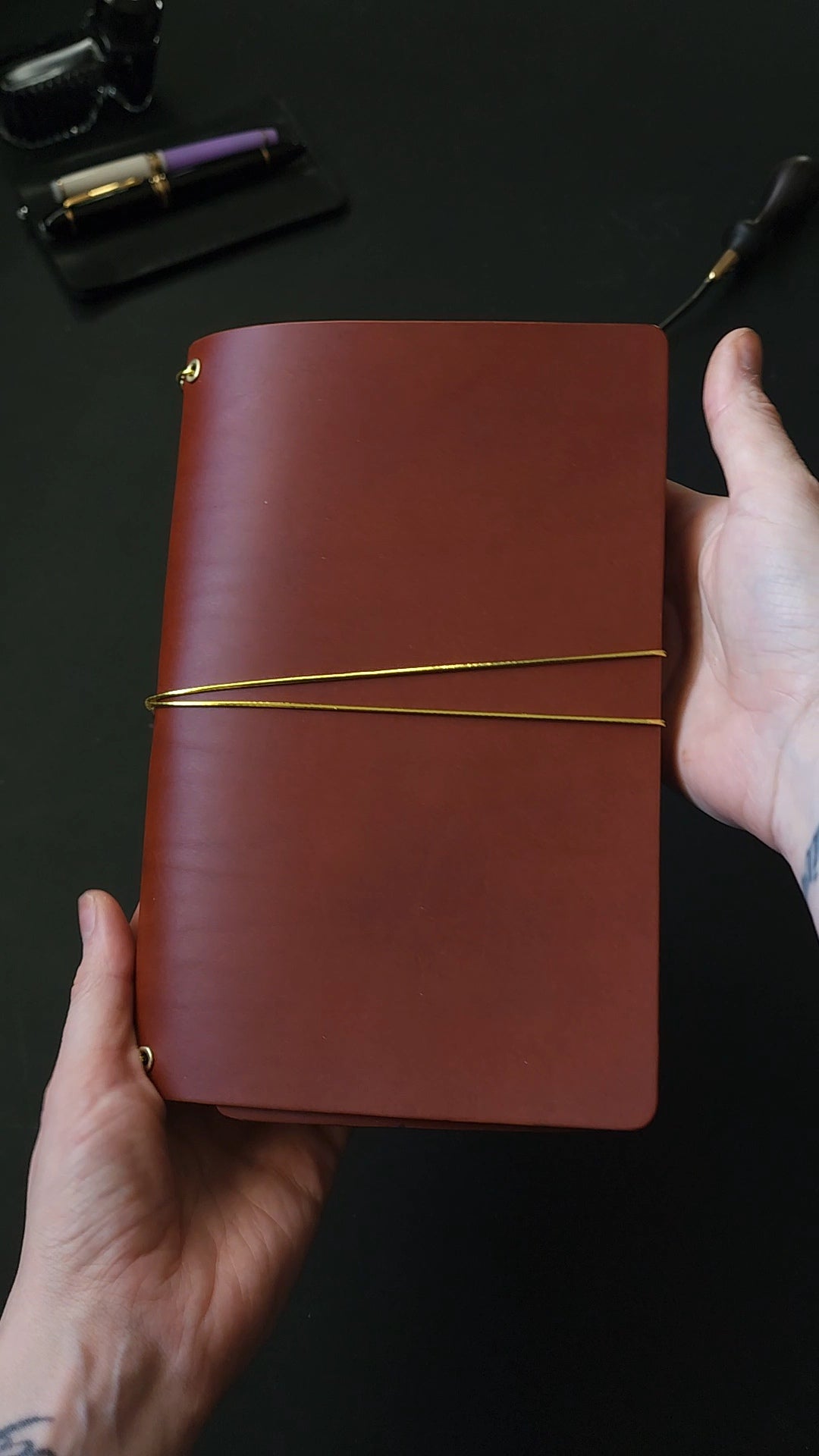 Oxblood trifold journal cover with gold elastics (one cover, no paper)