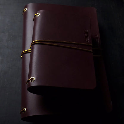 Oxblood trifold journal cover with gold elastics (one cover, no paper)