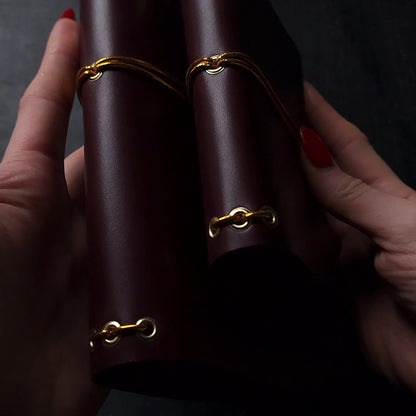 Oxblood trifold journal cover with gold elastics (one cover, no paper)