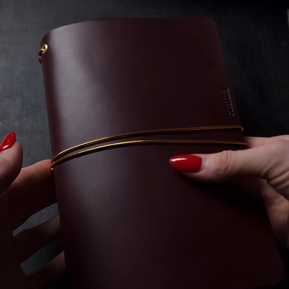 Oxblood trifold journal cover with gold elastics (one cover, no paper)
