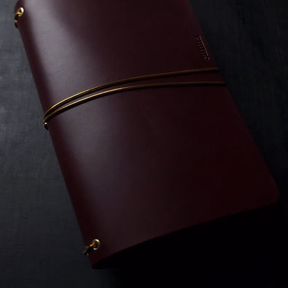 Oxblood trifold journal cover with gold elastics (one cover, no paper)