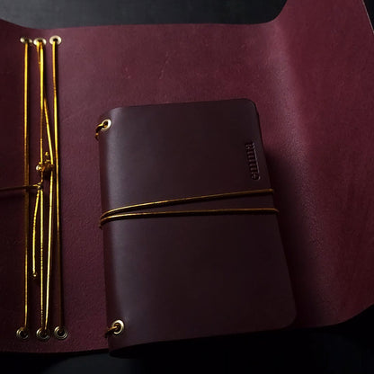 Oxblood trifold journal cover with gold elastics (one cover, no paper)
