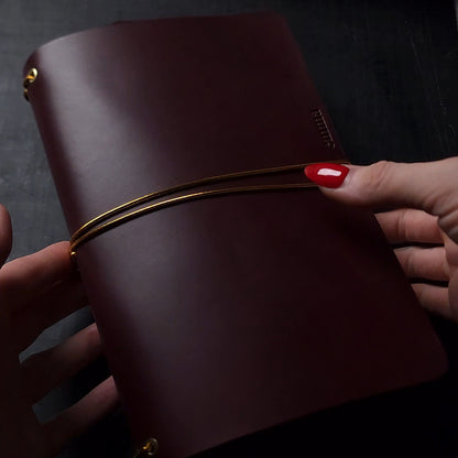 Oxblood trifold journal cover with gold elastics (one cover, no paper)