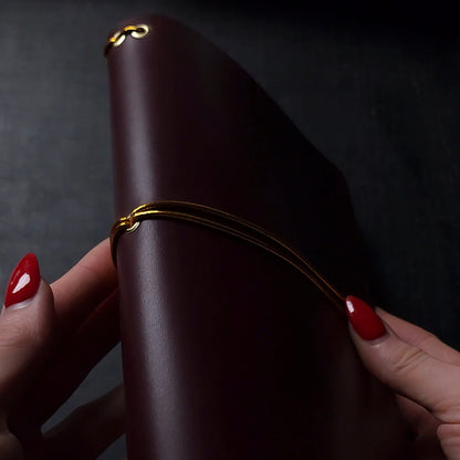 Oxblood trifold journal cover with gold elastics (one cover, no paper)
